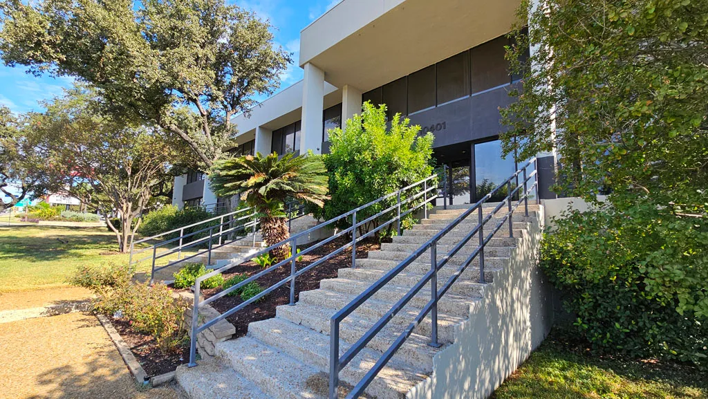 Front steps and accessibility ramp leading up to the main building entrance