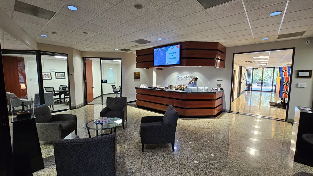 Kinected Coworking lobby with reception desk and waiting area chairs