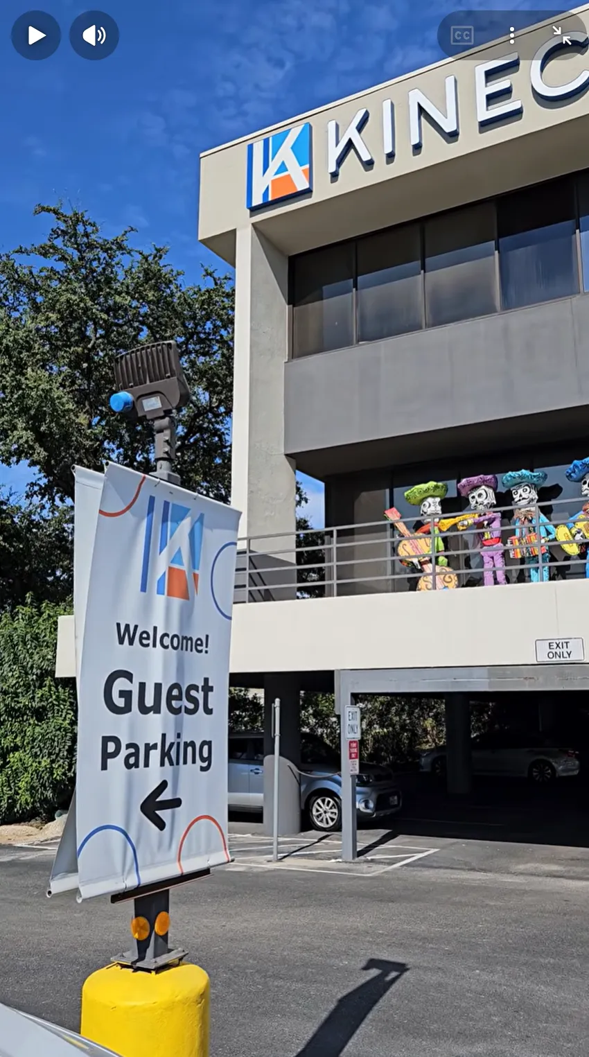 Video walkthrough thumbnail showing the Kinected Coworking guest parking sign and building entrance